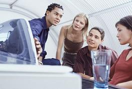 Four people working at a computer